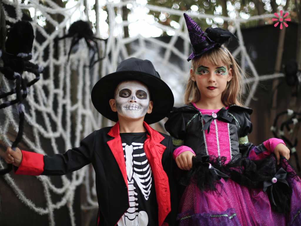a young boy and a young girl dressed in halloween costumes