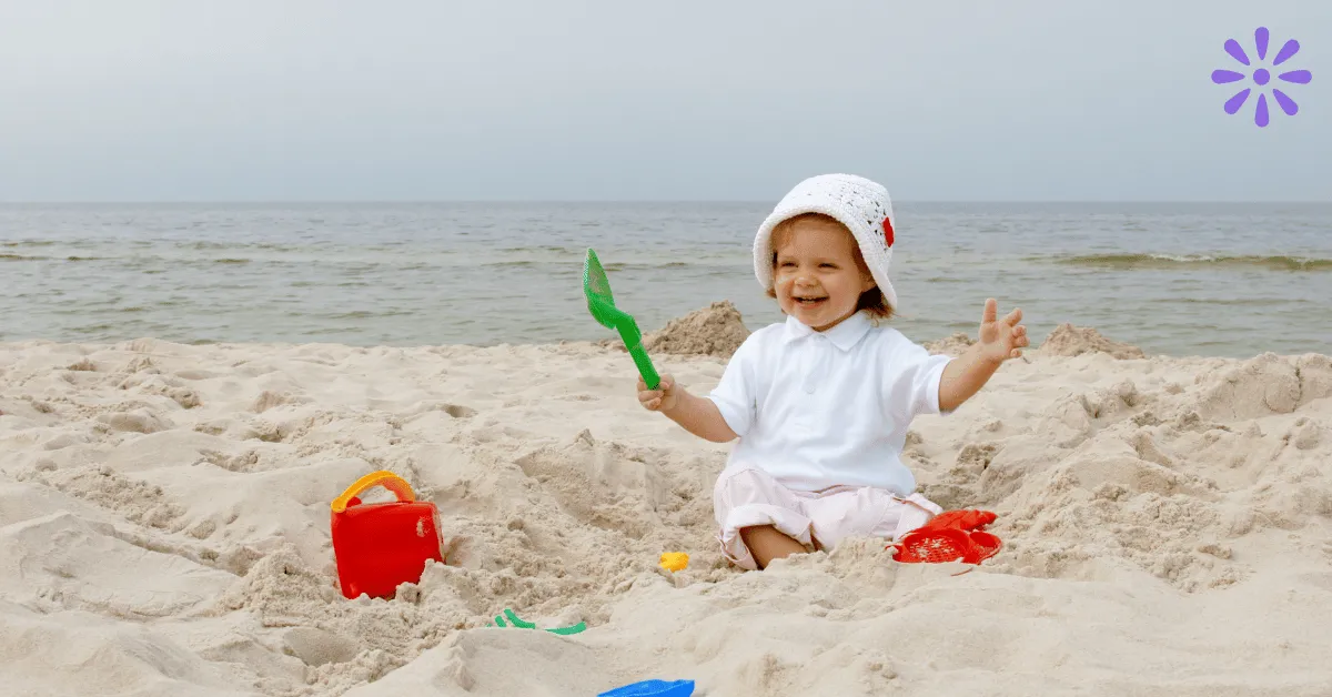 baby at the beach surrounded by toys, one of many baby beach hacks