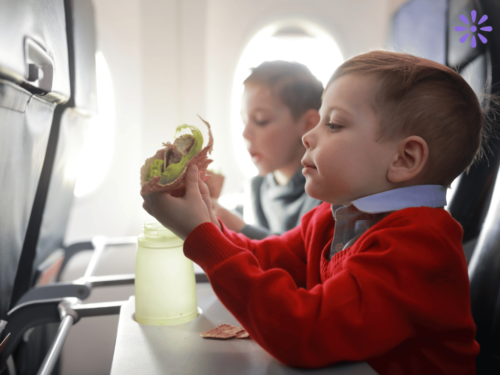 toddler eating a healthy snack on a plane